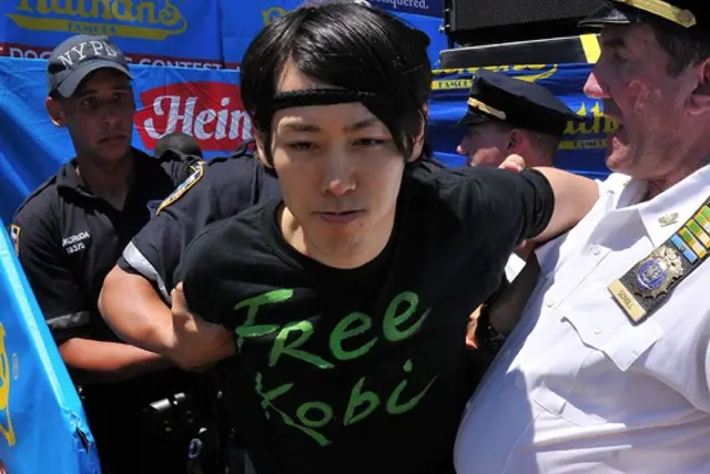 Kobayashi being arrested at last year's Nathan's Famous Hot Dog Eating Contest
